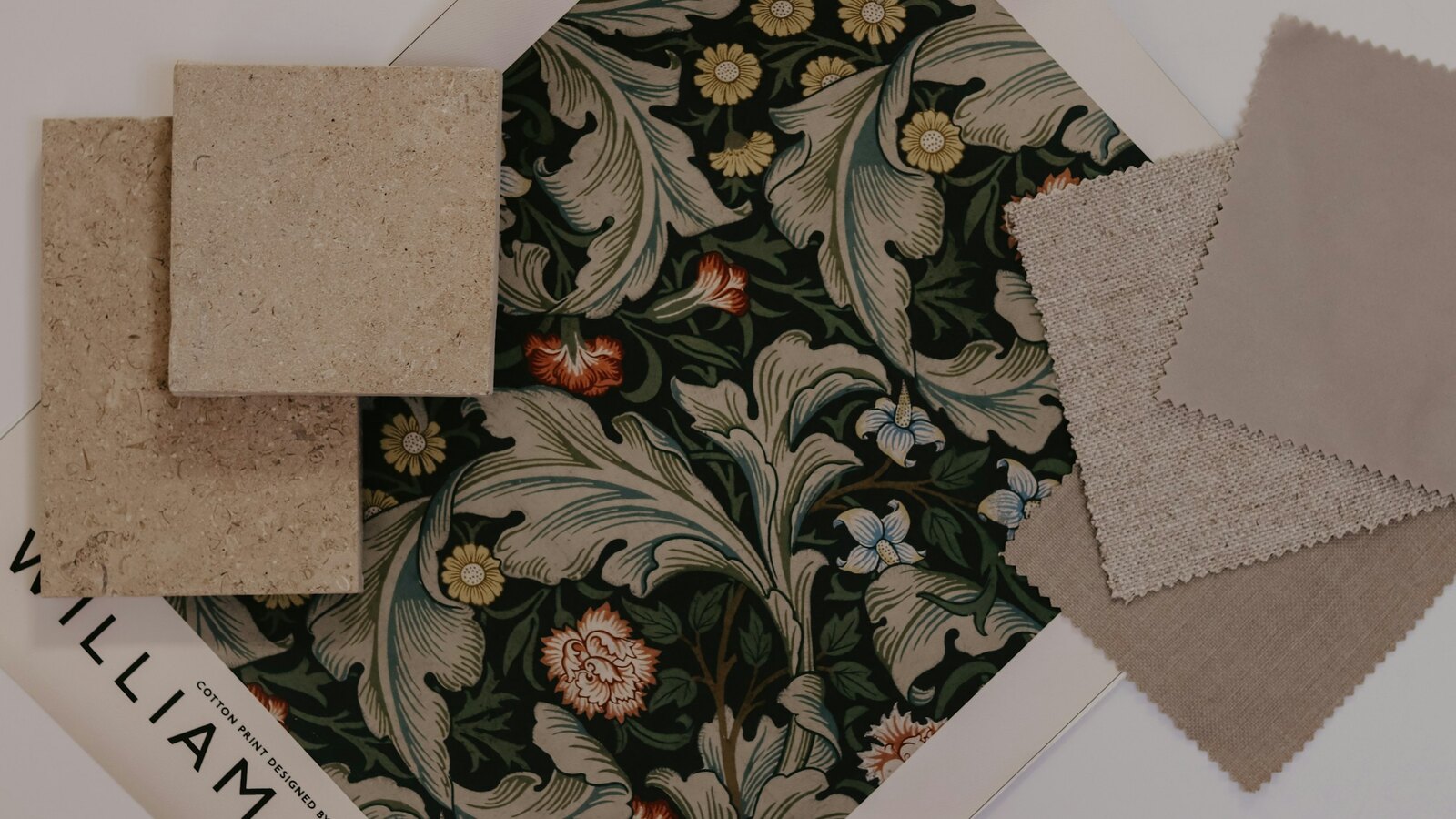 A wedding mood board with fabric swatches and flowers