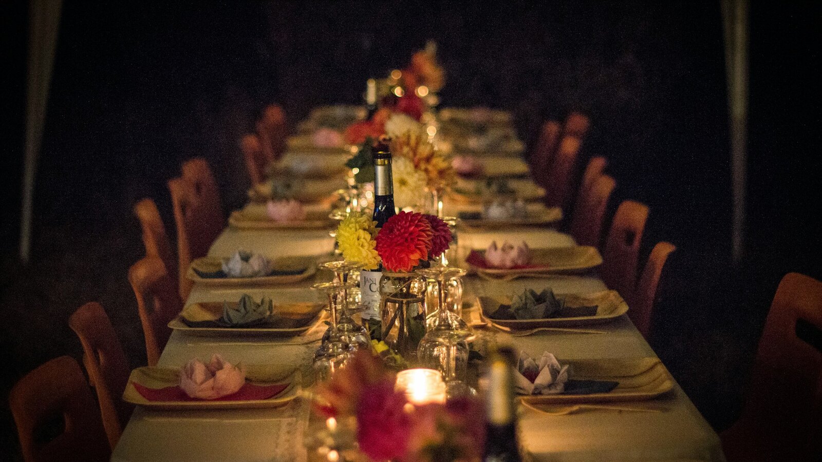 A candlelit wedding reception dinner in warm light